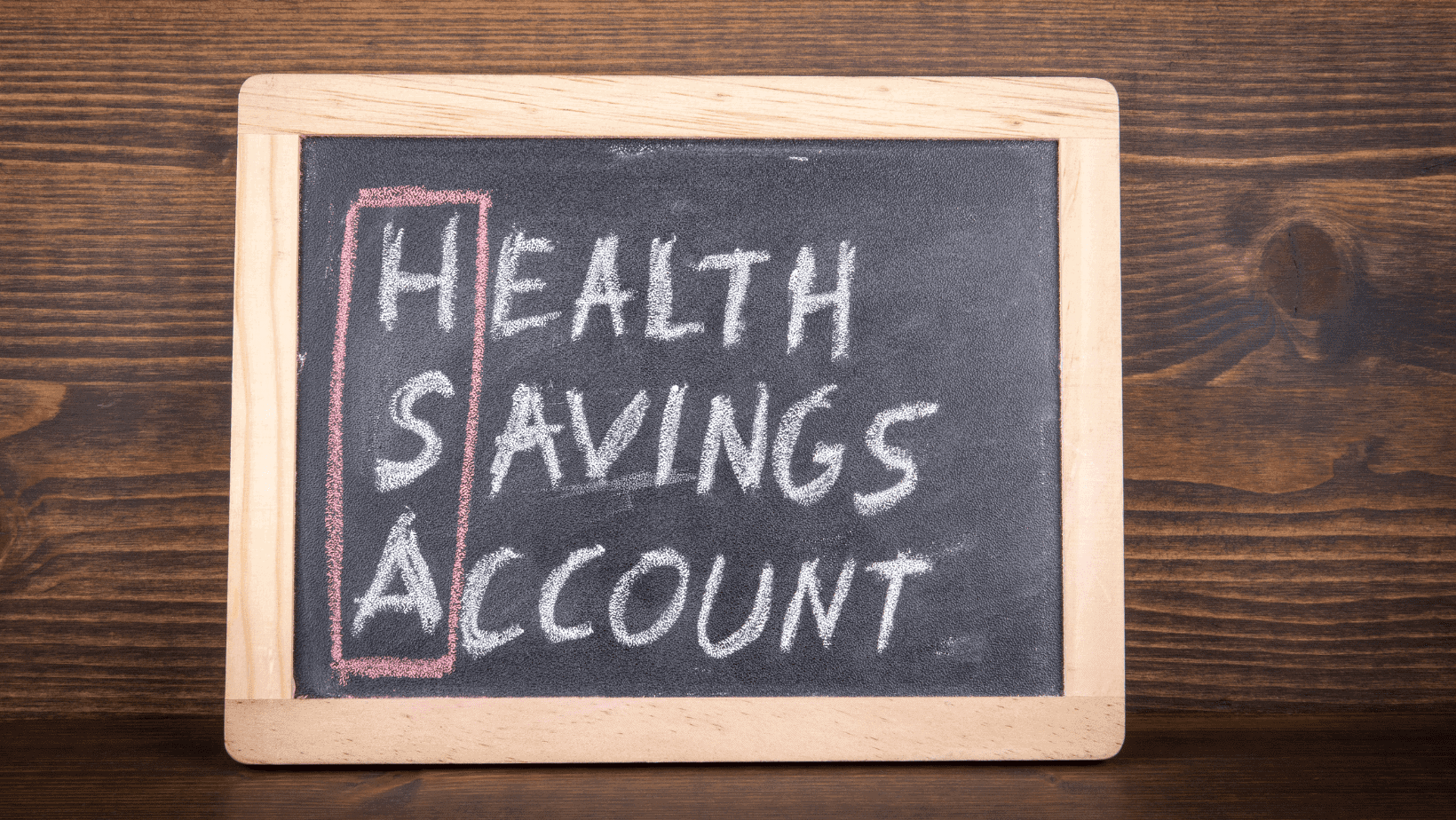 Chalkboard with "Health Savings Account" written on it in colorful chalk.