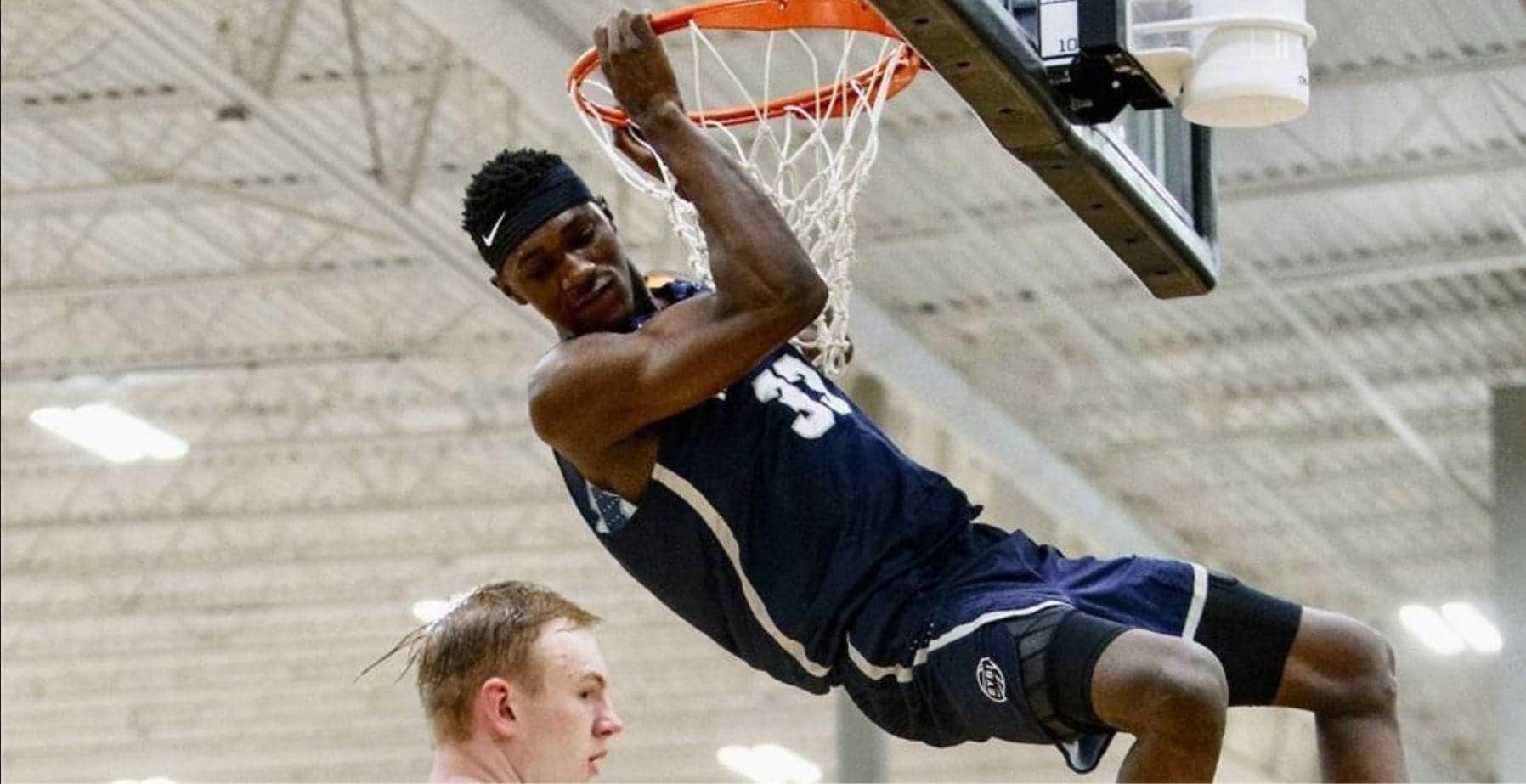 Capture Dunking basketball player in action during game.