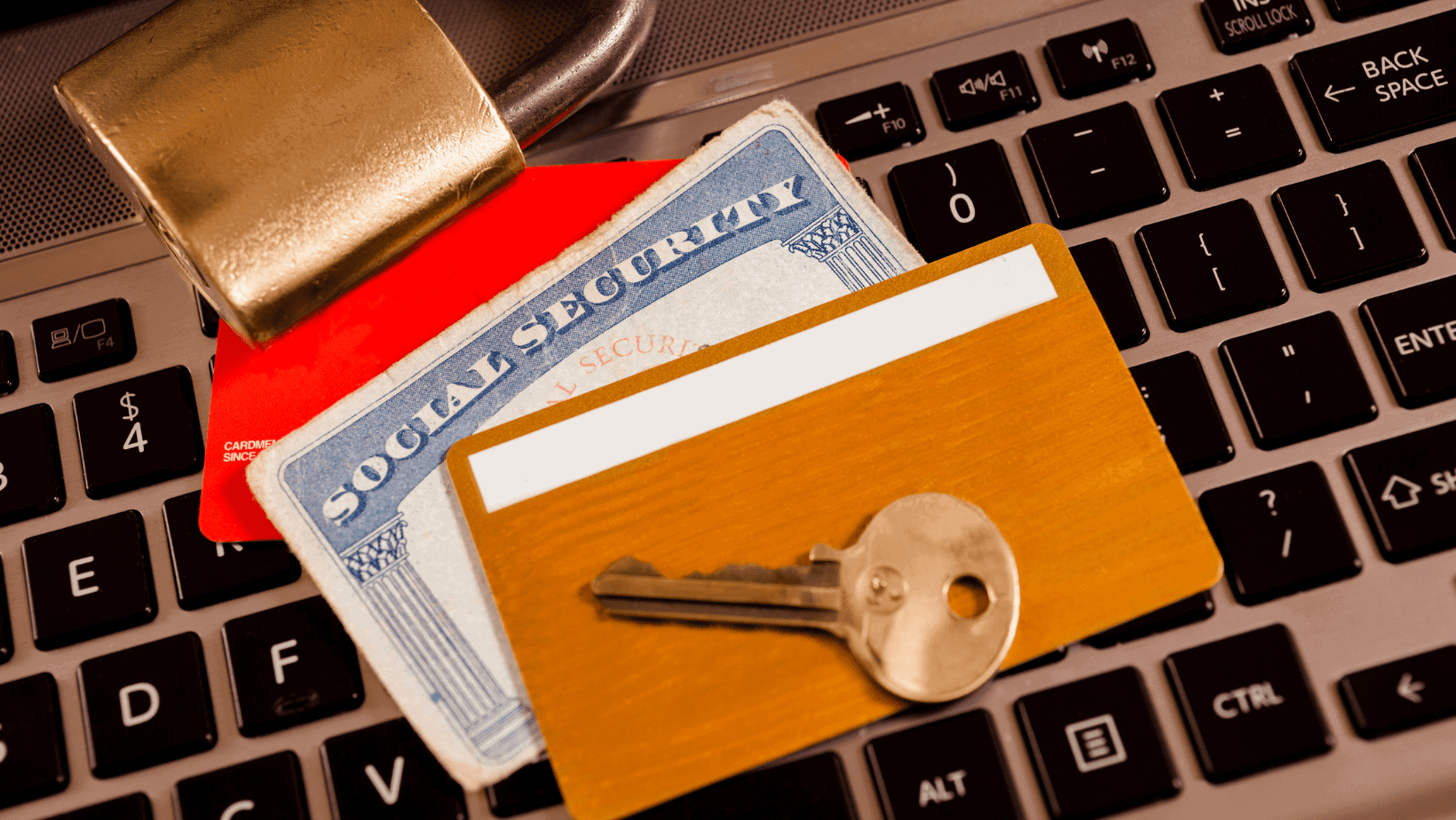 Lock, credit card, and key on a keyboard representing online security.