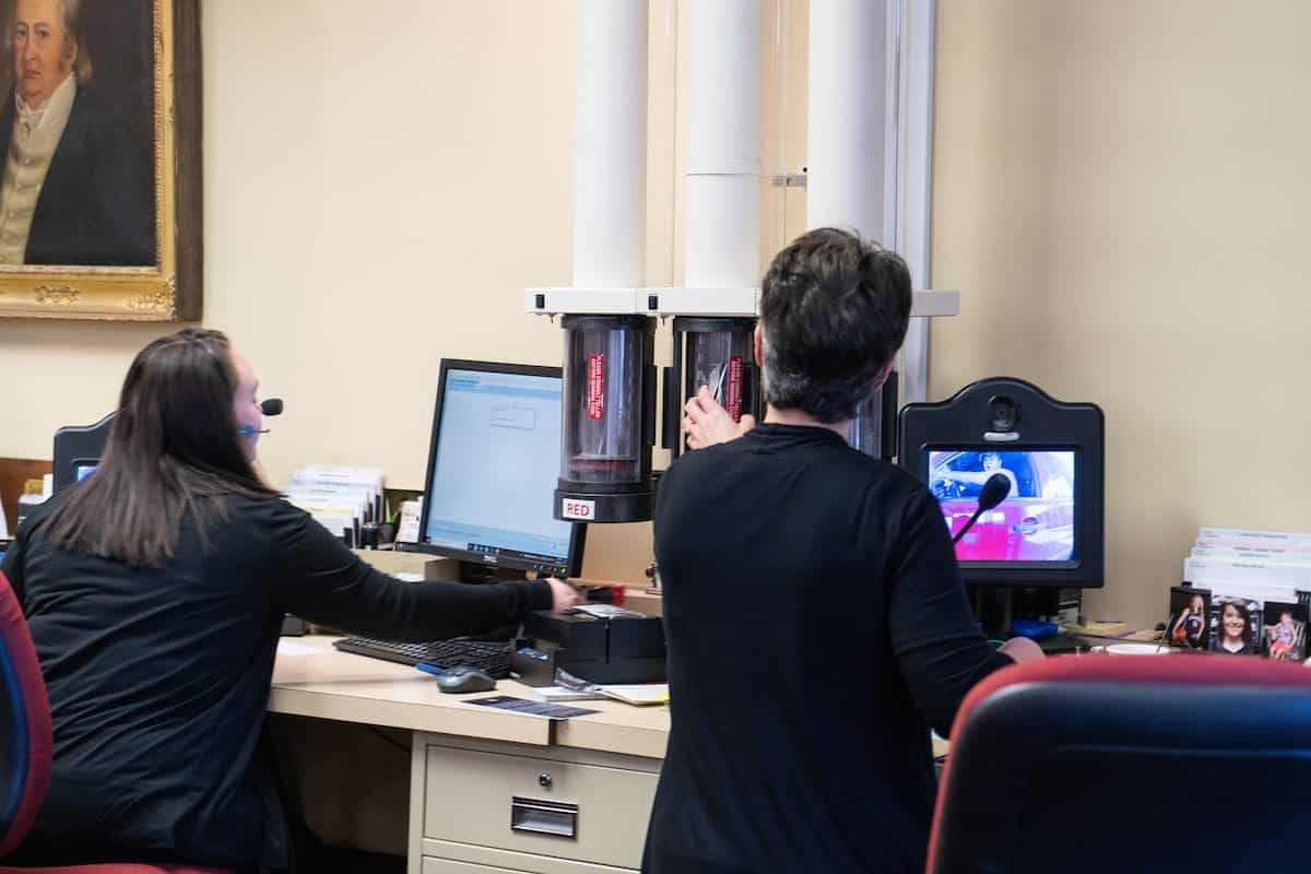 tellers working with customers sending via tubes tellers working with customers sending via tubes