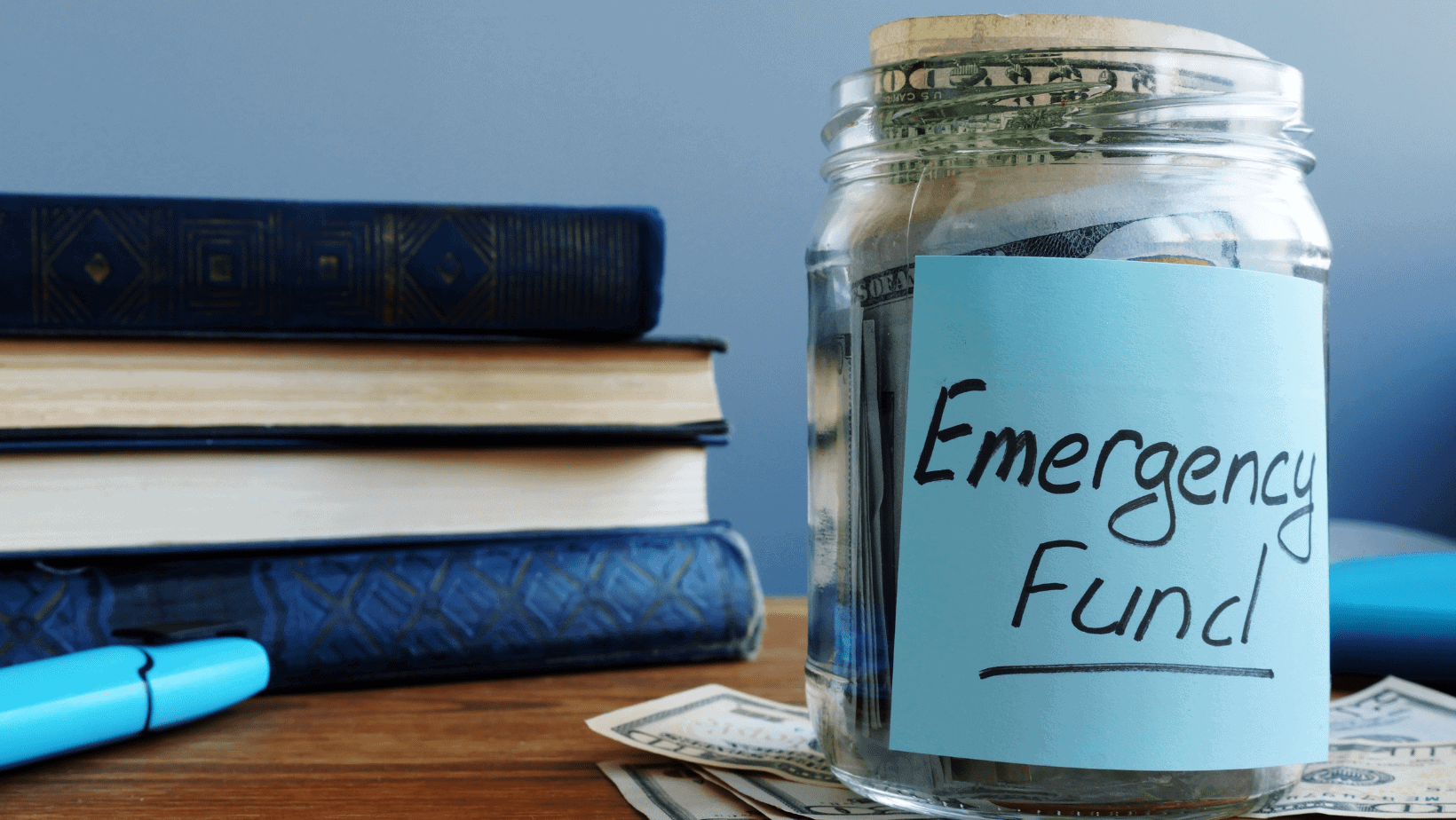 A jar with cash that says Emergency Fund