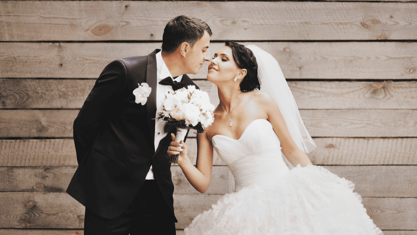 Bride and groom exchanging a loving glance during their wedding ceremony.