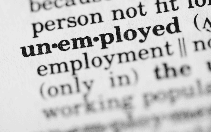 Close-up of a printed page highlighting the word "unemployed".