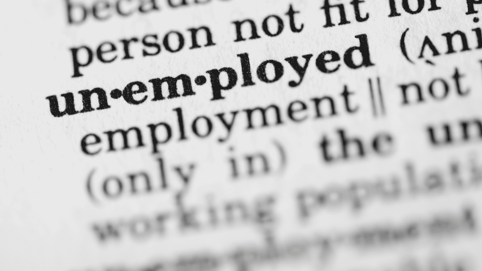 Close-up of a printed page highlighting the word "unemployed".