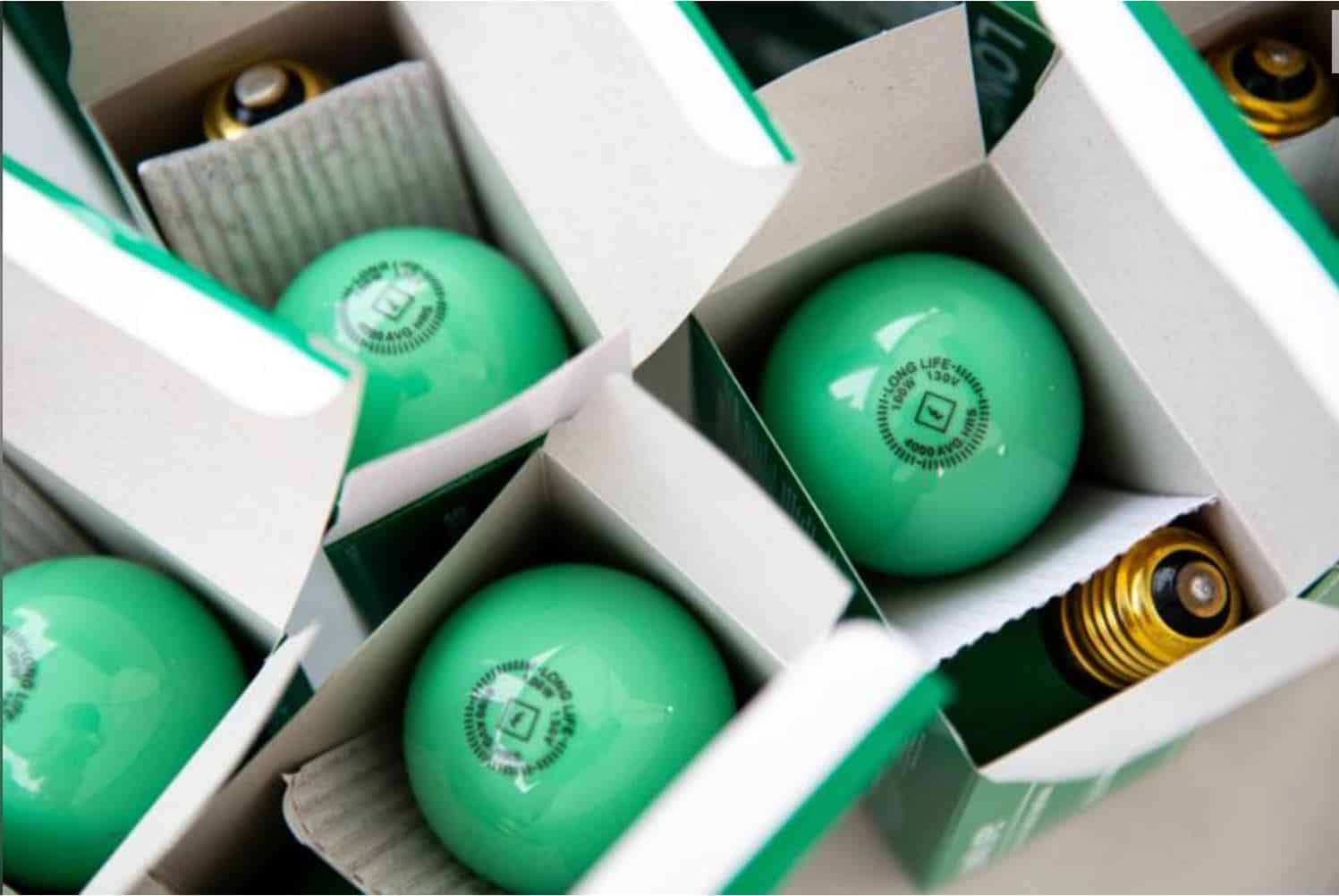 Green energy-saving light bulbs in packaging boxes.
