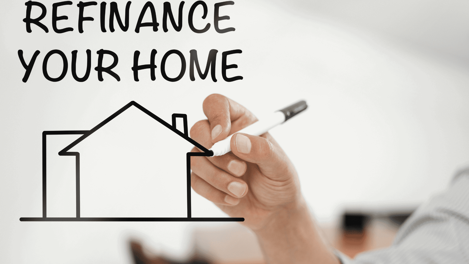 Person drawing a house with a marker, promoting home refinancing services.